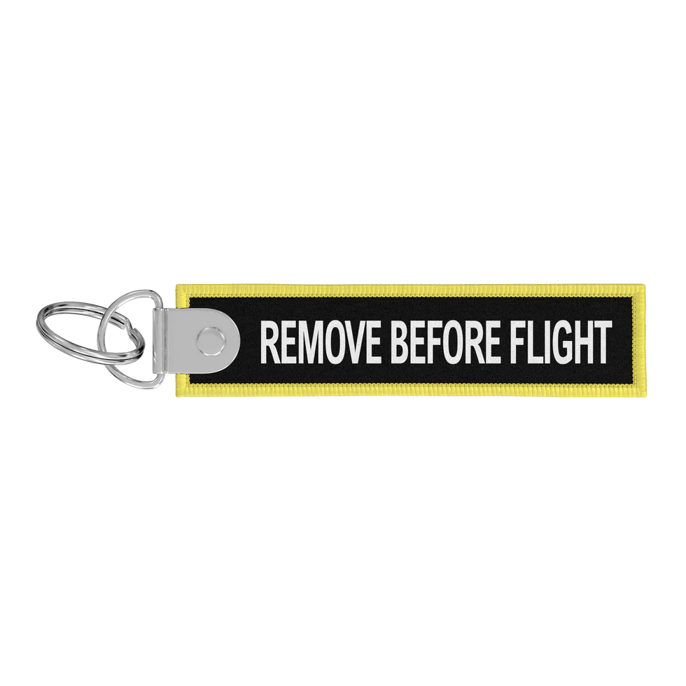 Porte-clés flamme Remove Before Flight noire / CDG
